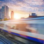 Train crossing in front of a London horizon