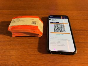 81 paper rail tickets alongside an iphone displaying a digital ticket alternative; split ticketing - paper versus digital 